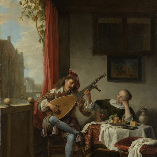 A person playing a guitar next to a person sitting on a chair

Description automatically generated with low confidence